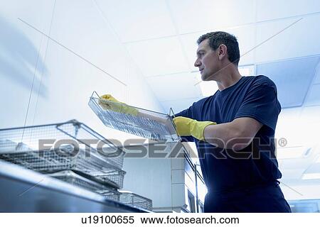 Worker putting surgical instruments into ultrasonic bath in surgical instrument factory View Large Photo Image Stock Photography - Worker putting surgical instruments into ultrasonic bath in surgical instrument factory. Fotosearch