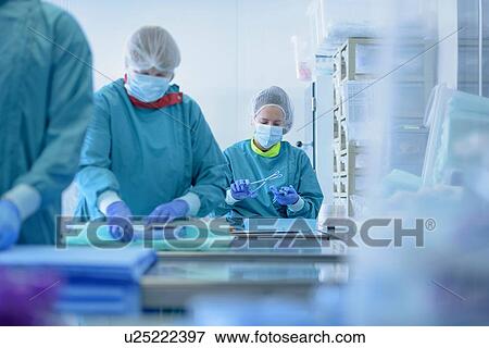 Workers inspecting surgical instruments in clean room of surgical instruments factory View Large Photo Image Stock Photo - Workers inspecting surgical instruments in clean room of surgical instruments factory. Fotosearch