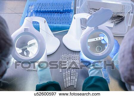 Workers inspecting surgical instruments in clean room of surgical instruments factory, close up View Large Photo Image Stock Photo - Workers inspecting surgical instruments in clean room of surgical instruments factory, close up. Fotosearch
