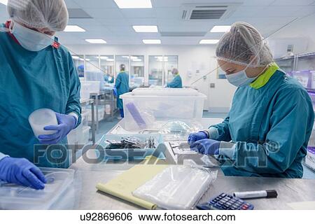 Workers packing surgical instruments in clean room of surgical instruments factory View Large Photo Image Stock Photograph - Workers packing surgical instruments in clean room of surgical instruments factory. Fotosearch