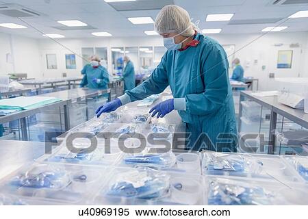 Workers packing surgical instruments in clean room of surgical instruments factory View Large Photo Image Stock Photography - Workers packing surgical instruments in clean room of surgical instruments factory. Fotosearch