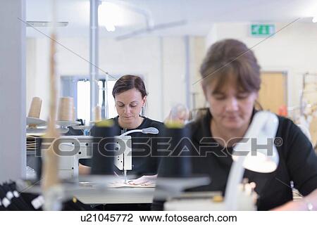 Stock Image - Workers sewing orthopaedic garments in factory. Fotosearch