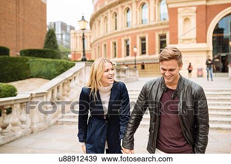 Stock Photo - Young couple hand in hand outside Albert Hall, London, England, UK. Fotosearch