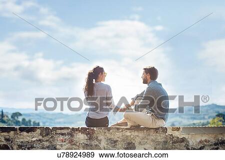 Young couple holding hands on wall in Florence hills, Italy View Large Photo Image Stock Photo - Young couple holding hands on wall in Florence hills, Italy. Fotosearch