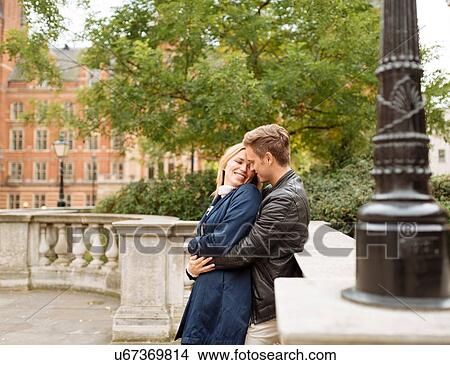 Picture - Young couple hugging outside Albert Hall, London, England, UK. Fotosearch