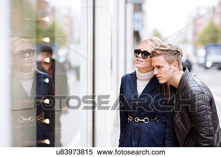 Young couple looking in shop window, London, England, UK View Large Photo Image Stock Photography - Young couple looking in shop window, London, England, UK. Fotosearch