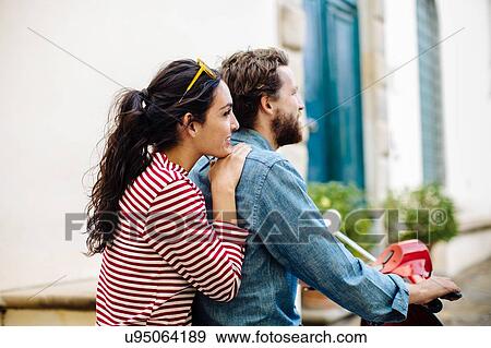 Young couple on moped looking at village, Florence, Italy View Large Photo Image Stock Photo - Young couple on moped looking at village, Florence, Italy. Fotosearch