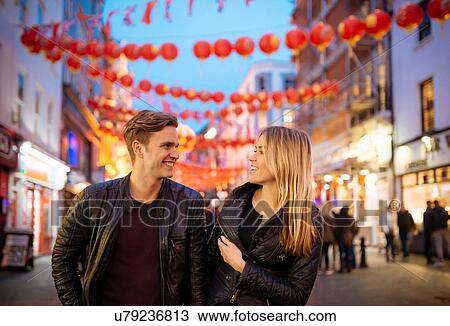 Young couple strolling at night, Chinatown, London, England, UK View Large Photo Image Stock Image - Young couple strolling at night, Chinatown, London, England, UK. Fotosearch