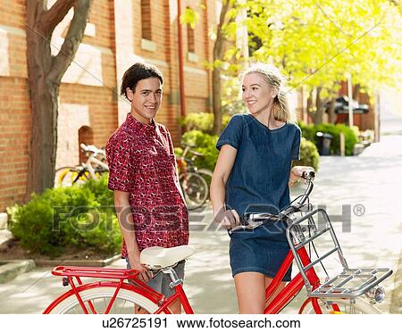 Stock Image - Young couple with bicycle, Southbank, Melbourne, Australia. Fotosearch