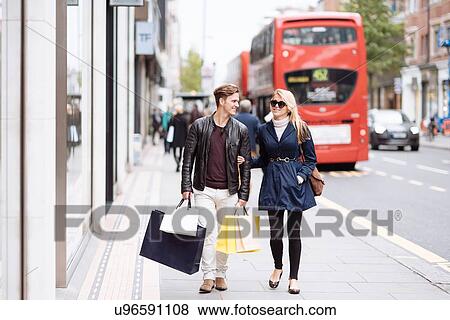 Young couple with shopping bags strolling, London, England, UK View Large Photo Image Stock Photo - Young couple with shopping bags strolling, London, England, UK. Fotosearch