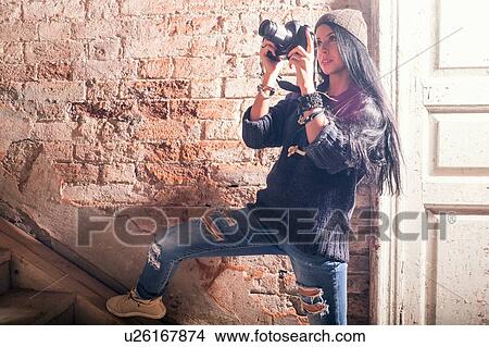 Young female photographer photographing stairs in old industrial building View Large Photo Image Picture - Young female photographer photographing stairs in old industrial building. Fotosearch