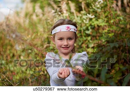 Stock Photo - Young girl in rural setting, exploring. Fotosearch
