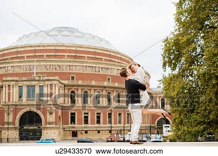 Young man lifting up girlfriend outside Albert Hall, London, England, UK View Large Photo Image Stock Image - Young man lifting up girlfriend outside Albert Hall, London, England, UK. Fotosearch