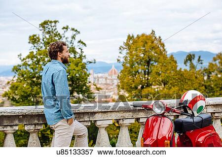 Young man looking at view from San Miniato church, Florence, Italy View Large Photo Image Stock Photo - Young man looking at view from San Miniato church, Florence, Italy. Fotosearch