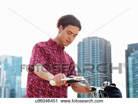 Young man on bicycle, Southbank, Melbourne, Australia View Large Photo Image Stock Image - Young man on bicycle, Southbank, Melbourne, Australia. Fotosearch
