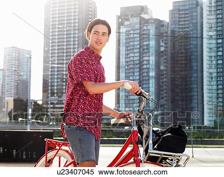 Young man on bicycle, Southbank, Melbourne, Australia View Large Photo Image Stock Photography - Young man on bicycle, Southbank, Melbourne, Australia. Fotosearch