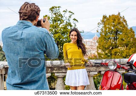 Young man photographing girlfriend in front of view from San Miniato church, Florence, Italy View Large Photo Image Stock Image - Young man photographing girlfriend in front of view from San Miniato church, Florence, Italy. Fotosearch