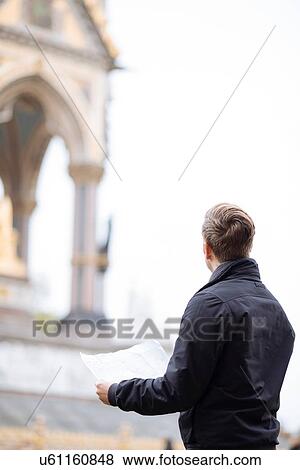 Young man with map looking up at Albert Memorial, London, England, UK View Large Photo Image Stock Photo - Young man with map looking up at Albert Memorial, London, England, UK. Fotosearch