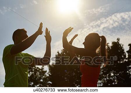 Young woman and man high fiving each other whilst training View Large Photo Image Stock Image - Young woman and man high fiving each other whilst training. Fotosearch