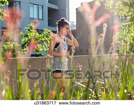 Young woman listening with earphones View Large Photo Image Stock Photo - Young woman listening with earphones. Fotosearch