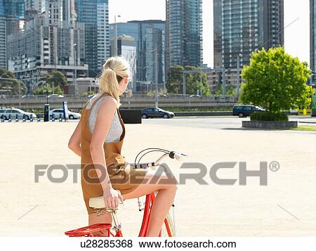 Young woman on bicycle, Southbank, Melbourne, Australia View Large Photo Image Stock Photo - Young woman on bicycle, Southbank, Melbourne, Australia. Fotosearch