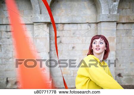 Young woman practising ribbon dance, walled arches in background View Large Photo Image Stock Photo - Young woman practising ribbon dance, walled arches in background. Fotosearch