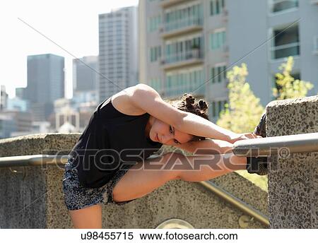Young woman stretching beside steps, Melbourne, Victoria, Australia View Large Photo Image Stock Photography - Young woman stretching beside steps, Melbourne, Victoria, Australia. Fotosearch
