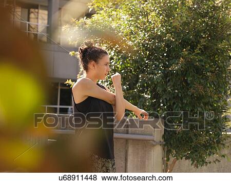 Young woman stretching View Large Photo Image Stock Photo - Young woman stretching. Fotosearch