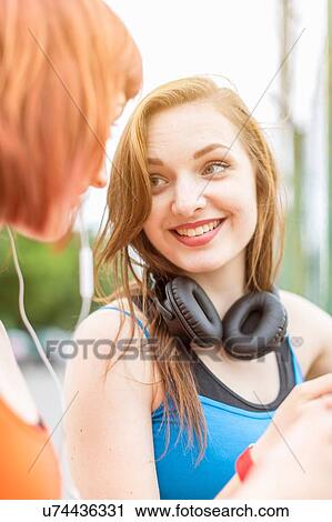 Stock Image - Young women chatting. Fotosearch
