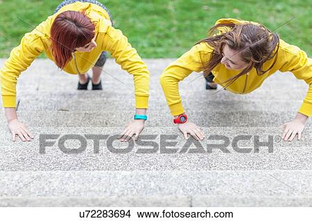 Young women doing push-ups on steps View Large Photo Image Picture - Young women doing push-ups on steps. Fotosearch