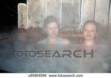 Young women enjoying hot tub View Large Photo Image Picture - Young women enjoying hot tub. Fotosearch