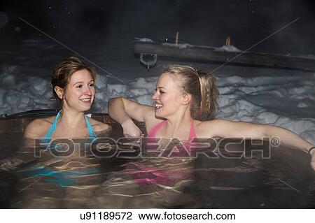 Young women enjoying hot tub View Large Photo Image Stock Image - Young women enjoying hot tub. Fotosearch