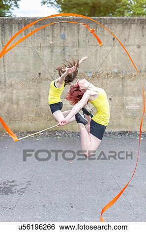 Young women practising ribbon dance on court View Large Photo Image Stock Photograph - Young women practising ribbon dance on court. Fotosearch
