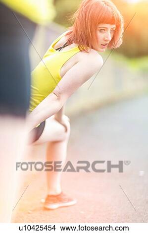 Young women stretching on walkway View Large Photo Image Picture - Young women stretching on walkway. Fotosearch