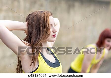 Young women stretching outdoors View Large Photo Image Stock Image - Young women stretching outdoors. Fotosearch