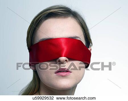 Stock Image - Woman wearing red blindfold. Fotosearch