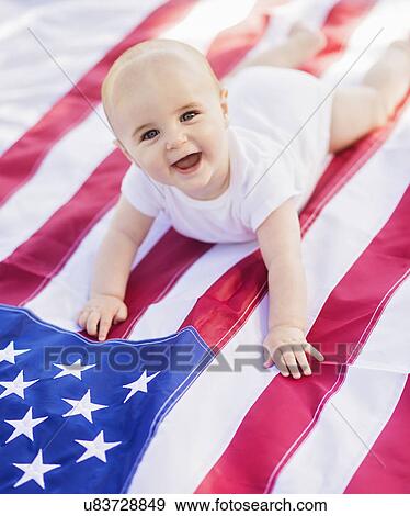 Baby boy (6-11 months) lying on American flag View Large Photo Image Stock Photo - Baby boy (6-11 months) lying on American flag. Fotosearch