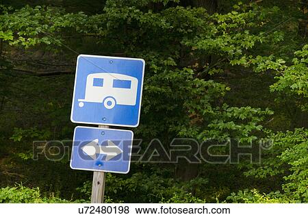 Blue road sign with forest in background View Large Photo Image Stock Photo - Blue road sign with forest in background. Fotosearch