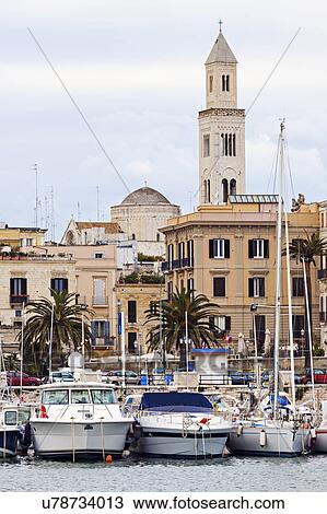 Boats in marina with city buildings in background View Large Photo Image Stock Image - Boats in marina with city buildings in background. Fotosearch