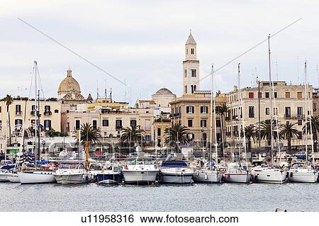 Boats in marina with city buildings in background View Large Photo Image Stock Photograph - Boats in marina with city buildings in background. Fotosearch