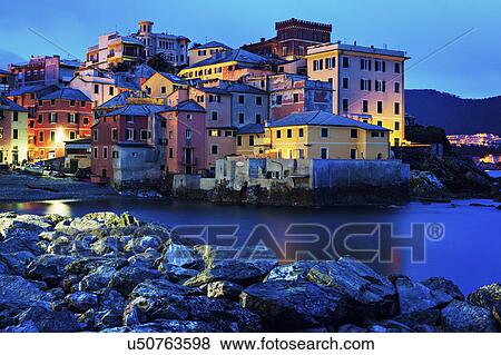 Stock Photo - Boccadasse harbor with city at sunrise. Fotosearch