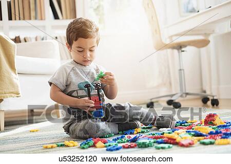 Boy (2-3) playing with toy blocks View Large Photo Image Stock Image - Boy (2-3) playing with toy blocks. Fotosearch