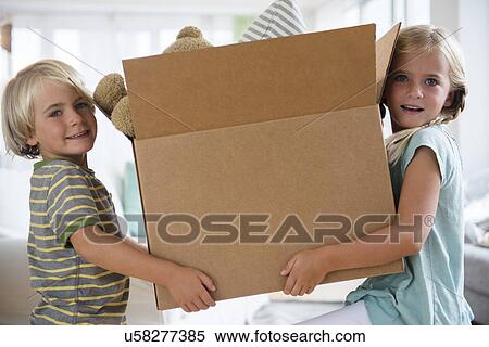 Boy (4-5) and girl (6-7) holding box View Large Photo Image Stock Photography - Boy (4-5) and girl (6-7) holding box. Fotosearch
