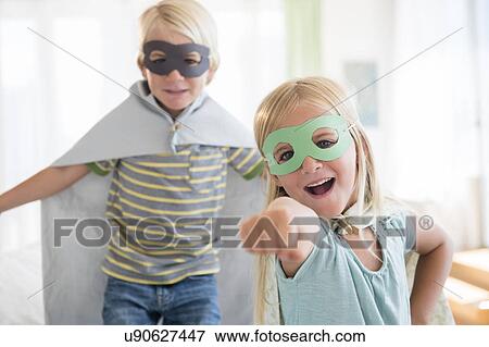 Boy (4-5) and girl (6-7) wearing masks View Large Photo Image Stock Photo - Boy (4-5) and girl (6-7) wearing masks. Fotosearch