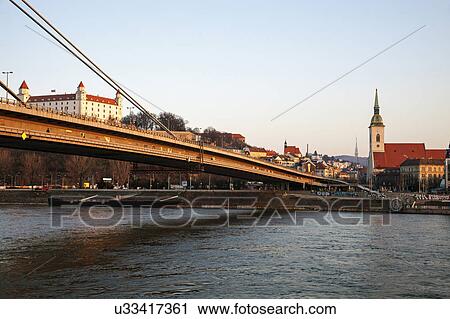 Bridge over water with city in background View Large Photo Image Stock Image - Bridge over water with city in background. Fotosearch