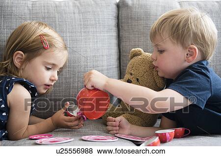 Brother (2-3) and sister (2-3) having tea party with teddy bear View Large Photo Image Stock Photo - Brother (2-3) and sister (2-3) having tea party with teddy bear. Fotosearch