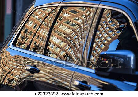 Stock Image - Building reflected in car. Fotosearch