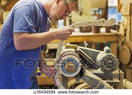 Carpenter polishing wood with sander View Large Photo Image Picture - Carpenter polishing wood with sander. Fotosearch