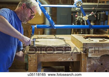 Carpenter working in workshop View Large Photo Image Stock Photography - Carpenter working in workshop. Fotosearch