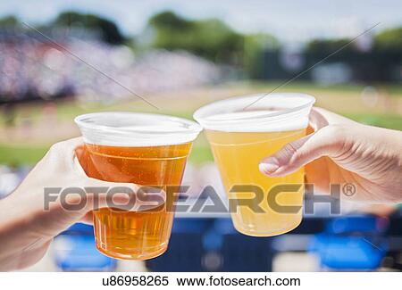 Stock Photography - Celebratory toast at stadium. Fotosearch